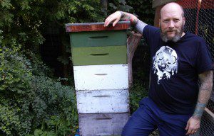 Mark McAlpine with one of the backyard hives.