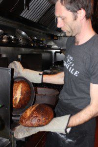 Holger removing the sourdough from the oven.