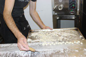 Holger pushes the completed  Gnocchi onto the tray for drying