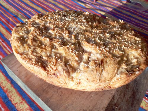 Overnight Sourdough with rosemary, rock salt, and sesame crust.