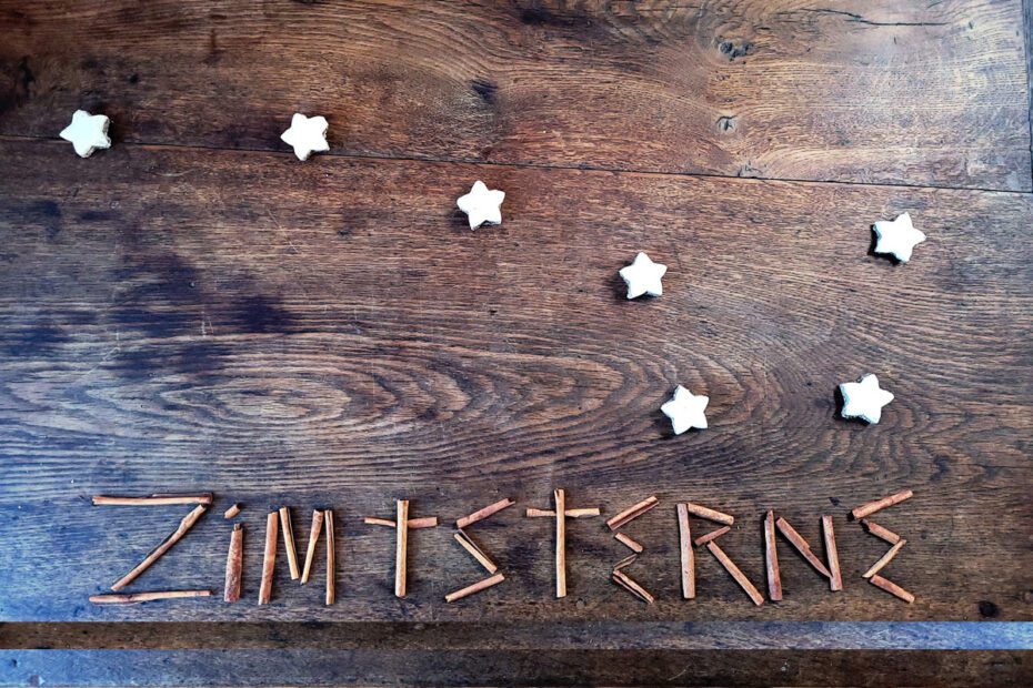 Zimtsterne (cinnamon stars) laid out as the Big Dipper, with the word Zimtsterne spelled out in cinnamon (zimpt) sticks.