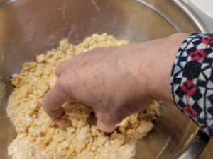 Mixing the marzipan crumble in a bowl