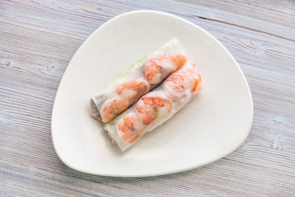 Vietnamese nem roll with shrimps on plate on table